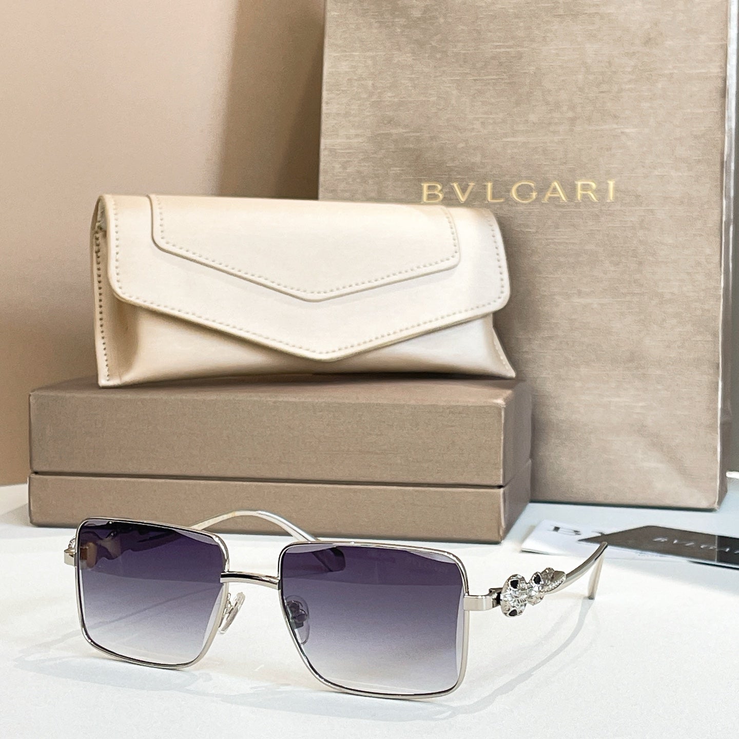 Silver-trim square sunglasses with dark purple gradient lenses and jeweled temple detail