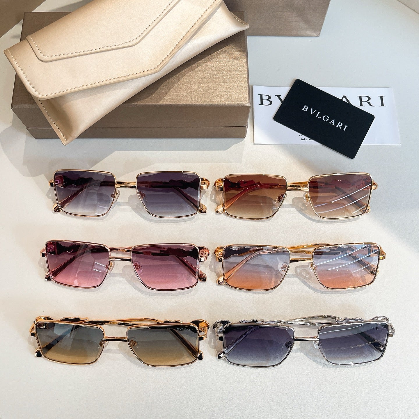 Assorted gold-framed square sunglasses with multicolor gradient lenses and jeweled temples