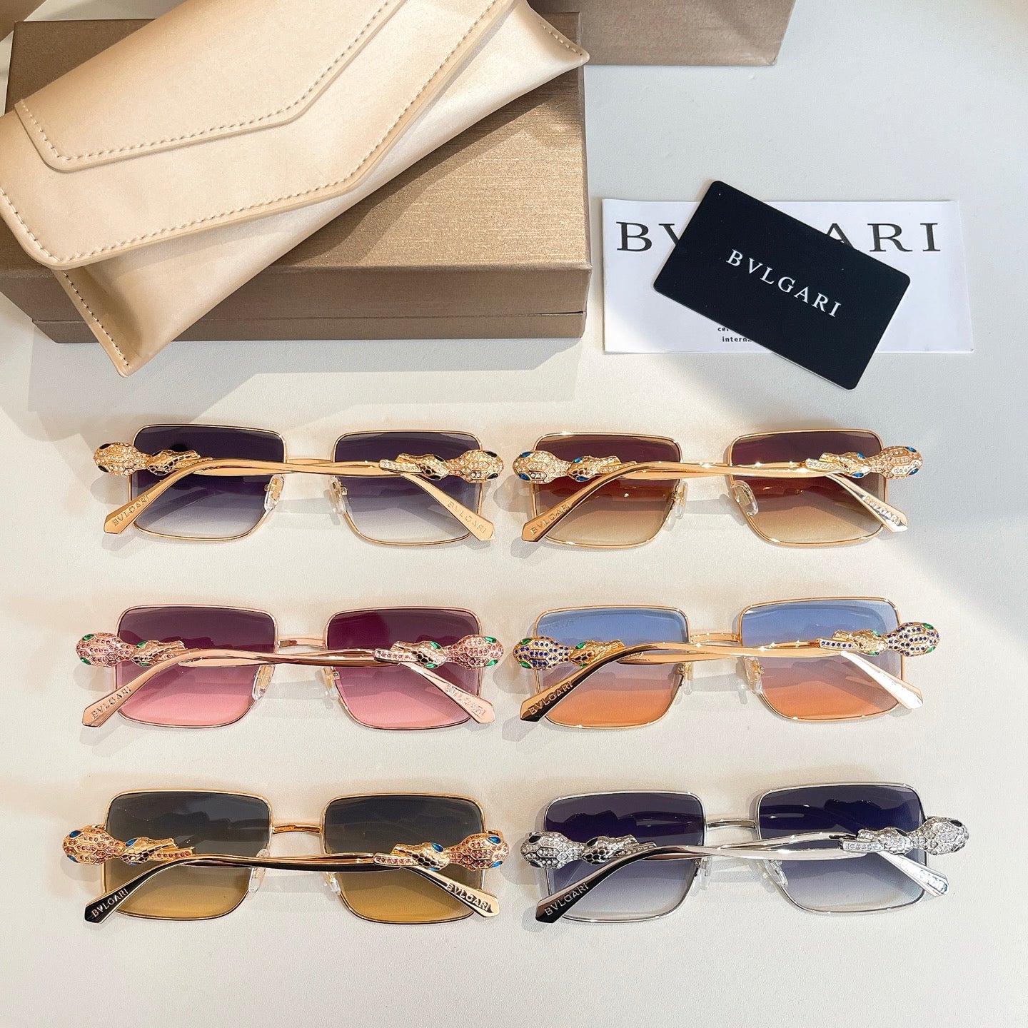 Assorted square sunglasses lineup with multicolor gradient lenses and jeweled frames