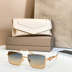Gold-framed square sunglasses with blue gradient lenses and jeweled temple detail