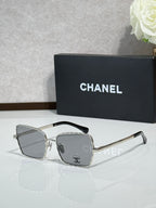Square silver-tone eyeglasses with gray lenses, Chanel logo on temples
