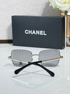 Square silver-tone eyeglasses with gray lenses, Chanel logo on temples