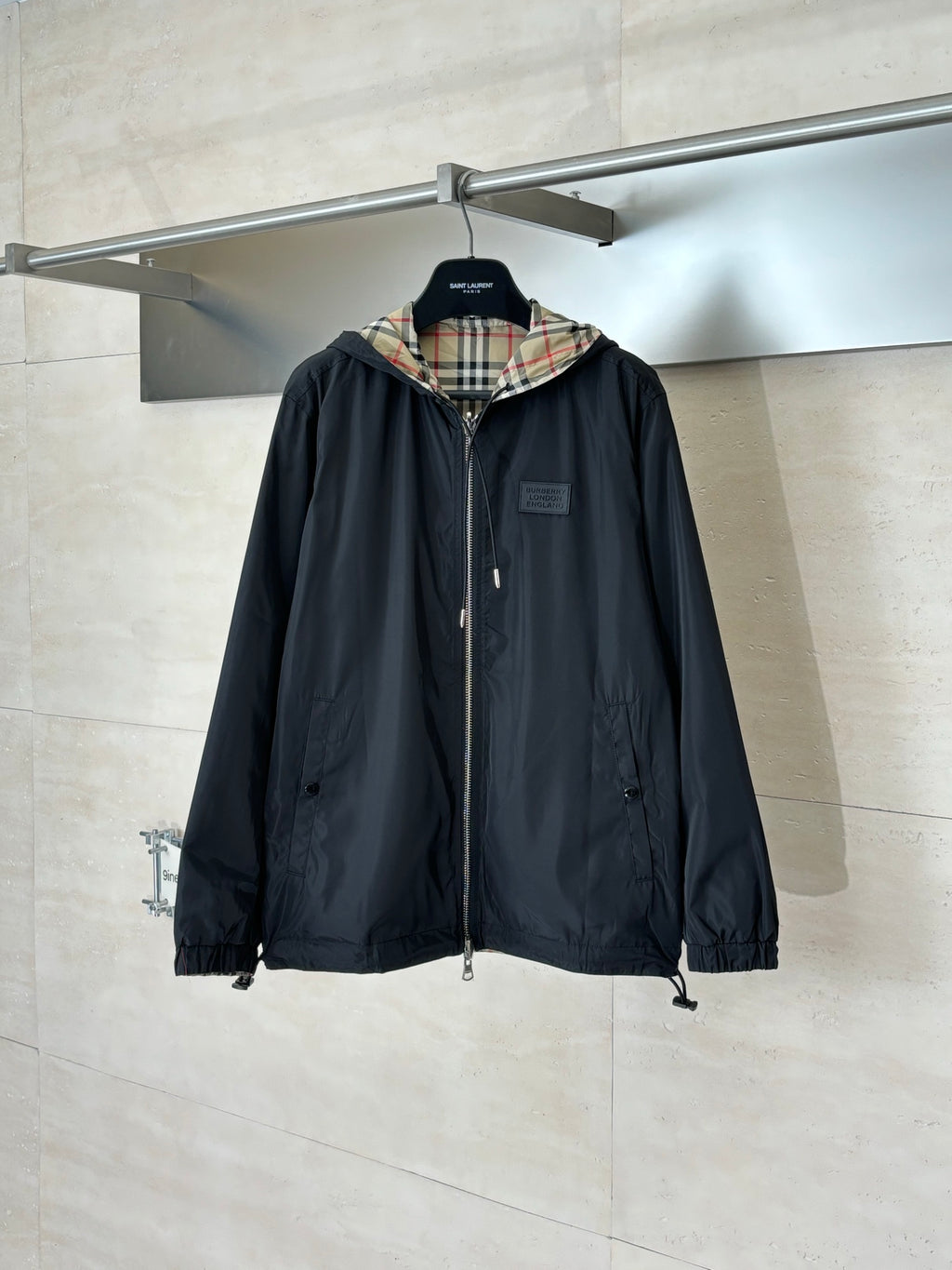 Kids black hooded windbreaker jacket with front zipper and drawstring hem
