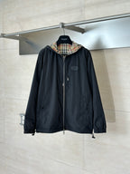 Black hooded jacket with front zipper and plaid-lined hood