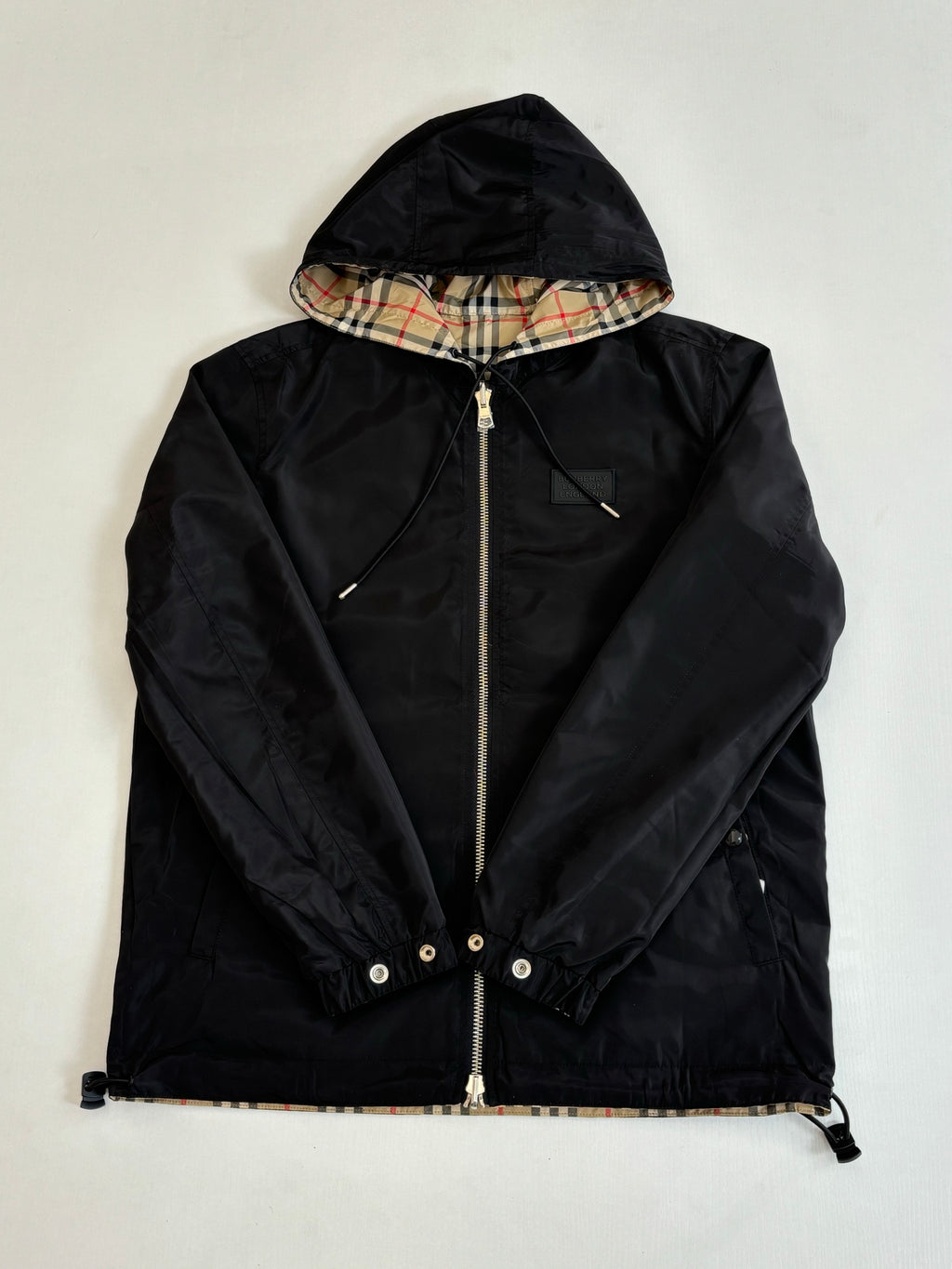 Kids black hooded jacket with zip front and adjustable hood lining