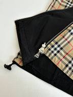 Side view close-up of kids black lining with zipper and plaid panel