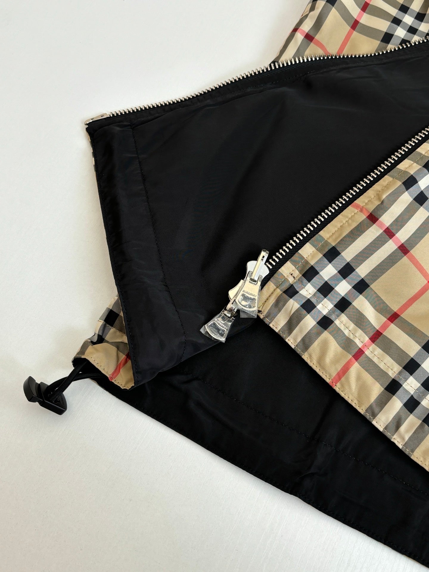 Side view close-up of kids black lining with zipper and plaid panel