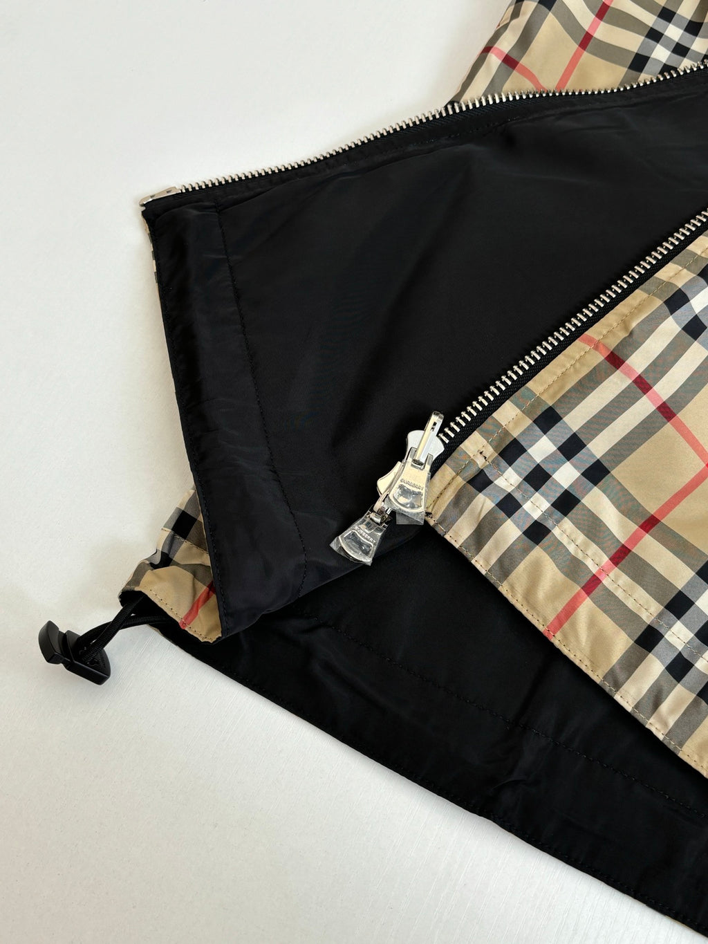 Black jacket lining with front zipper and plaid inner panel