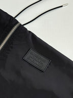 Black nylon jacket with front zipper and Burberry London England logo patch