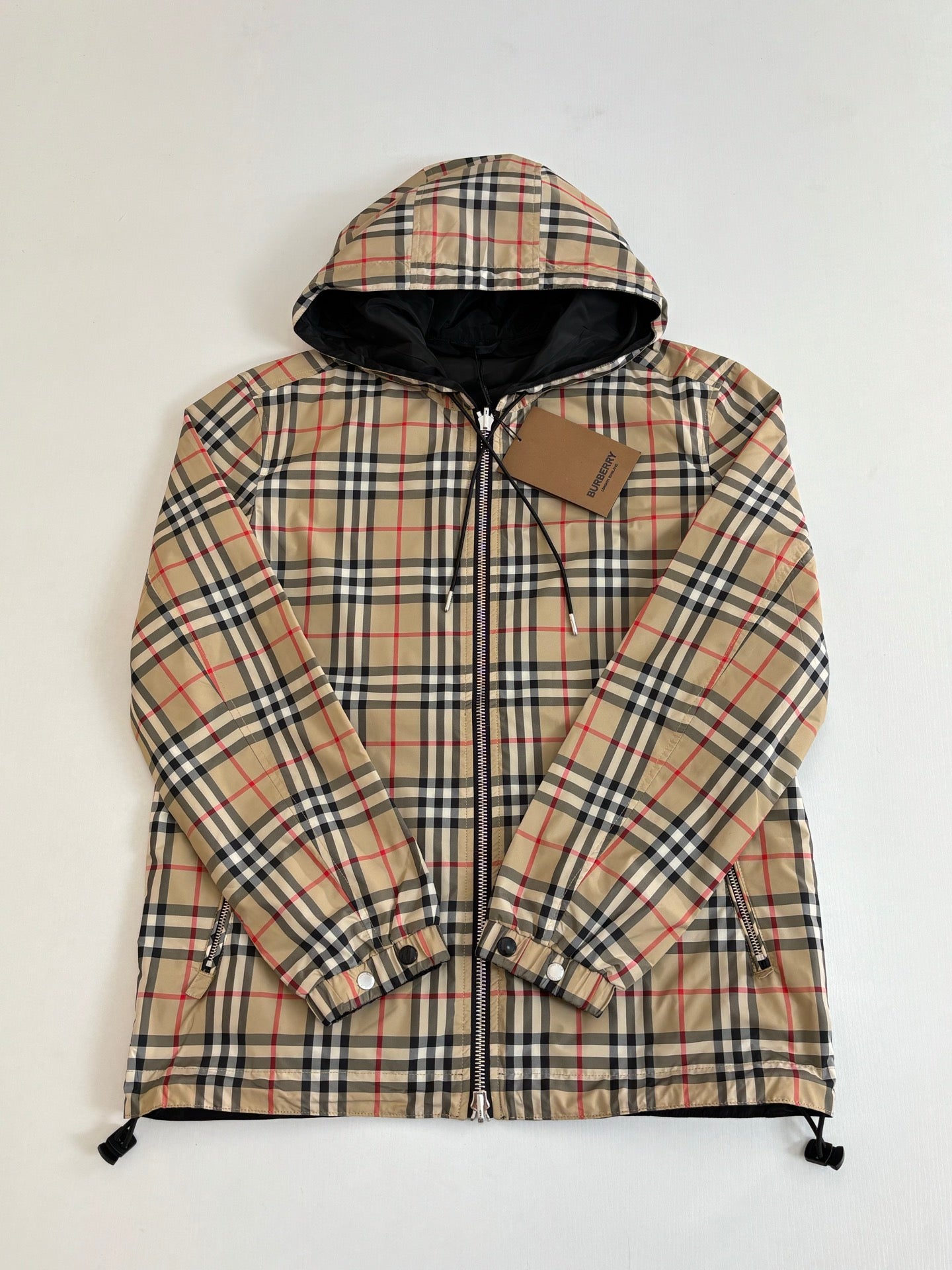 Kids hooded plaid jacket with zip front, button cuffs, and drawstring hem