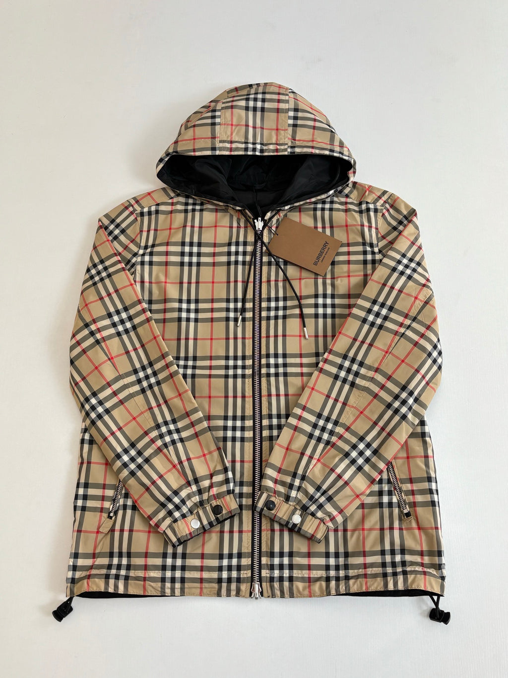 Plaid hooded jacket with full front zipper, long sleeves, and drawstring hem