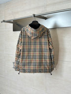 Plaid hooded jacket with black lining, front zipper, and drawcord hem