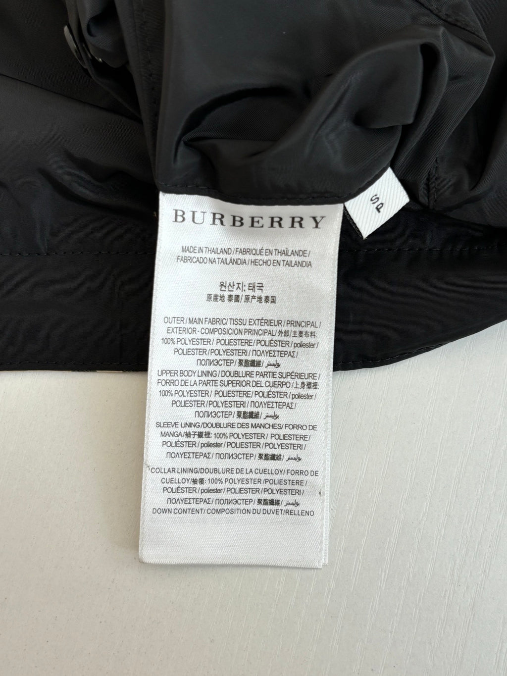 Black jacket with Burberry size and care label on inside collar
