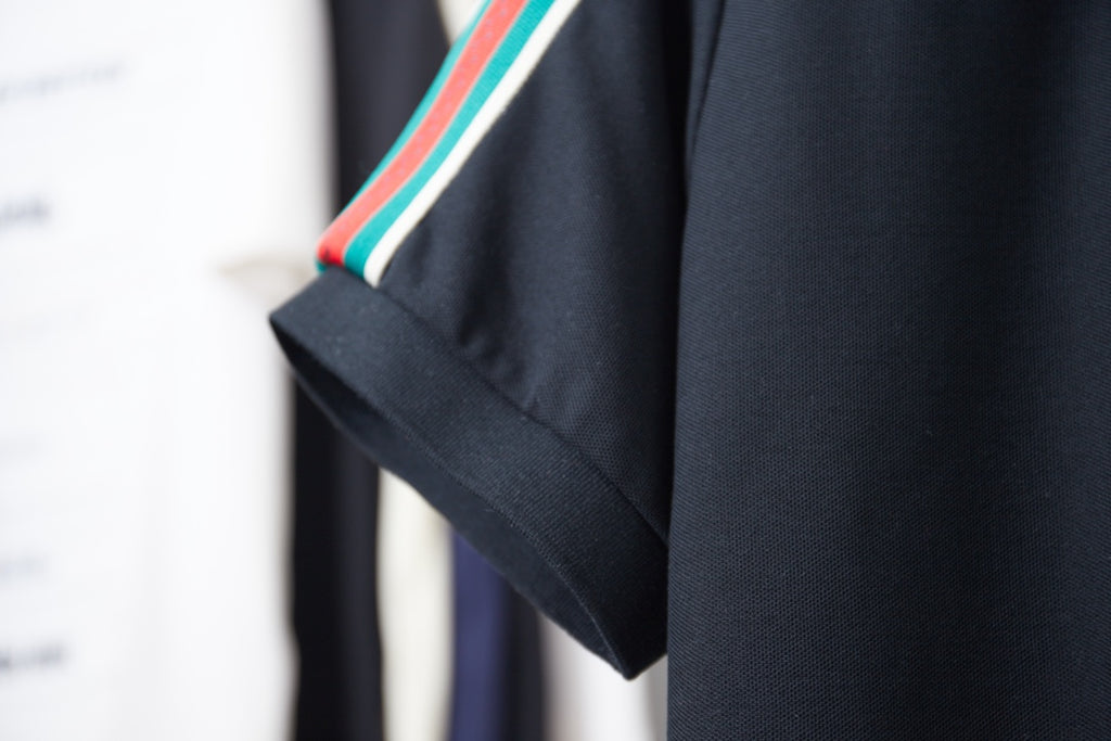 Gucci polo sleeve edge with multicolor stripe trim on navy short sleeve