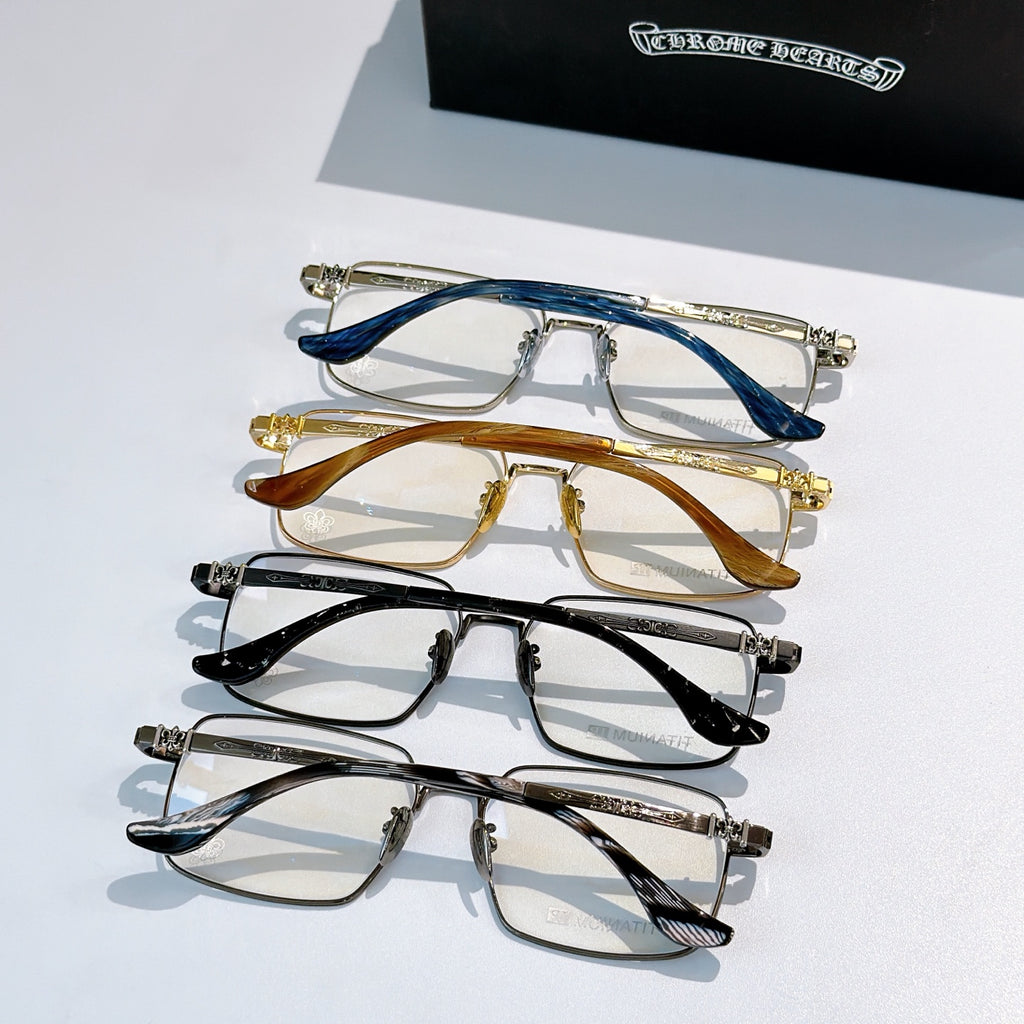 Stack of metal eyeglasses with blue, amber, and black temples and clear lenses