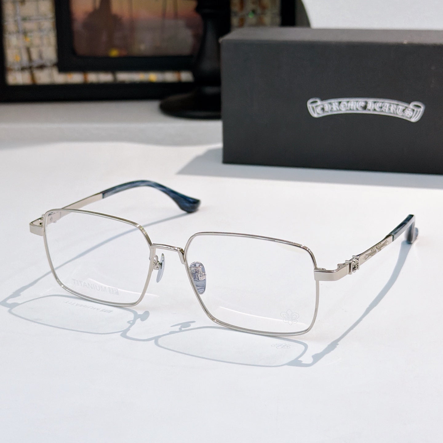 Chrome frame rectangular eyeglasses with blue temples and clear lenses