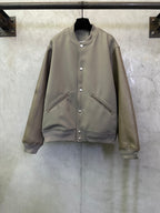 Olive long-sleeve jacket with snap button front and zip pocket details