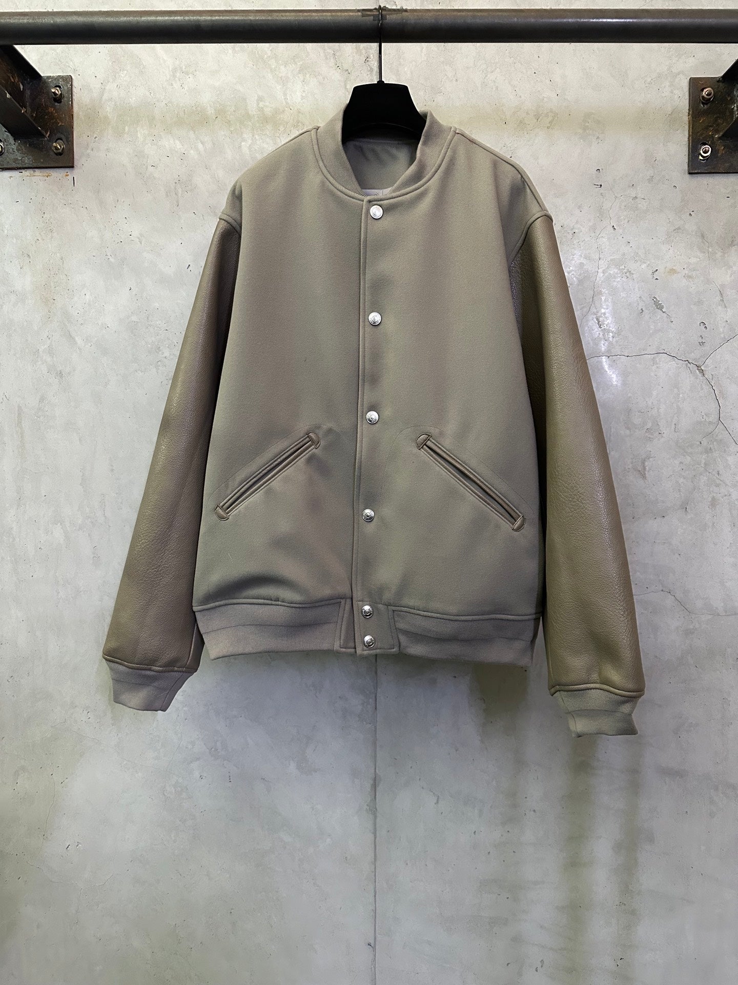 Olive long-sleeve jacket with snap button front and zip pocket details
