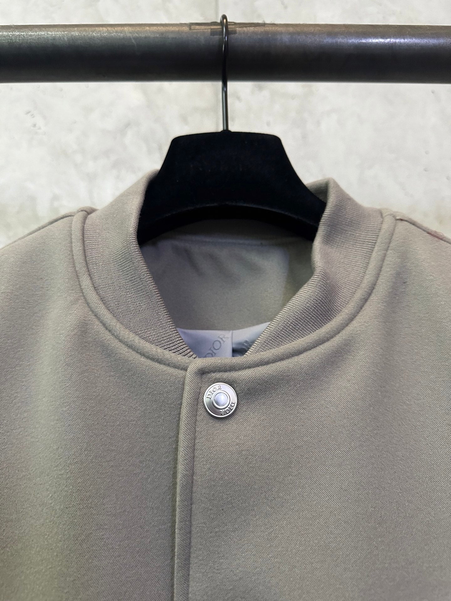 Olive long-sleeve jacket collar with snap button closure