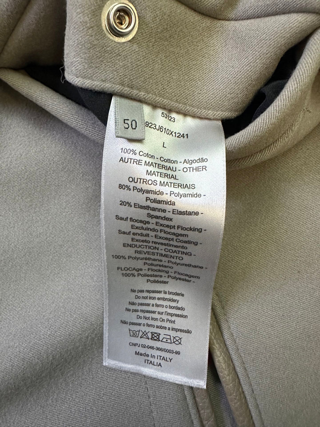 Clothing care label sewn inside neck, showing materials and washing instructions