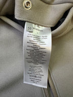 Clothing care label sewn inside neck, showing materials and washing instructions