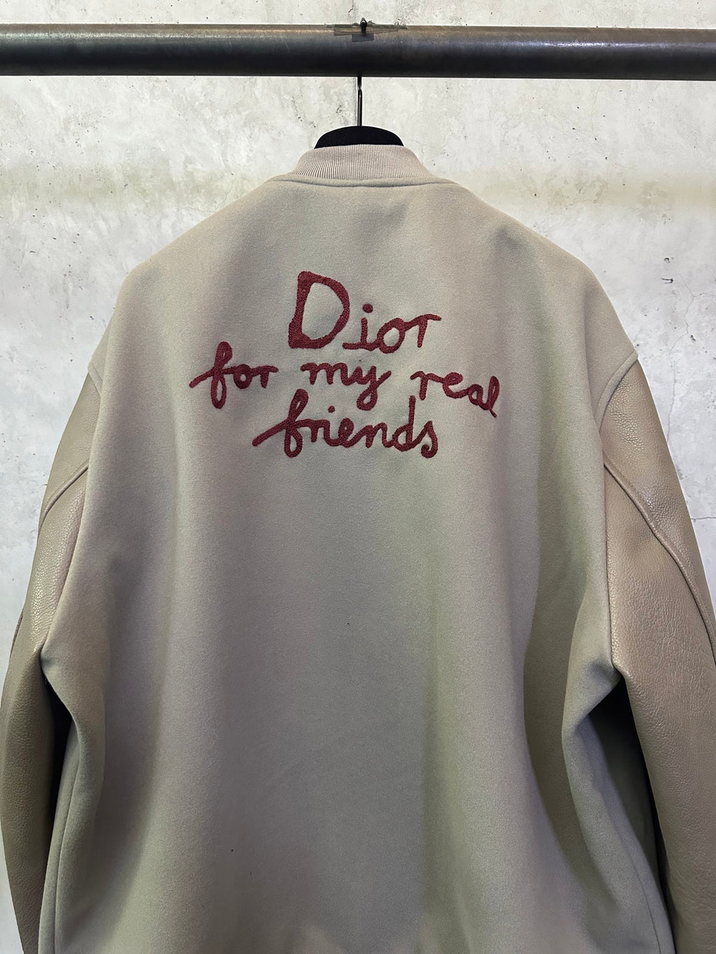 Olive jacket back featuring burgundy “Dior for my real friends” graphic