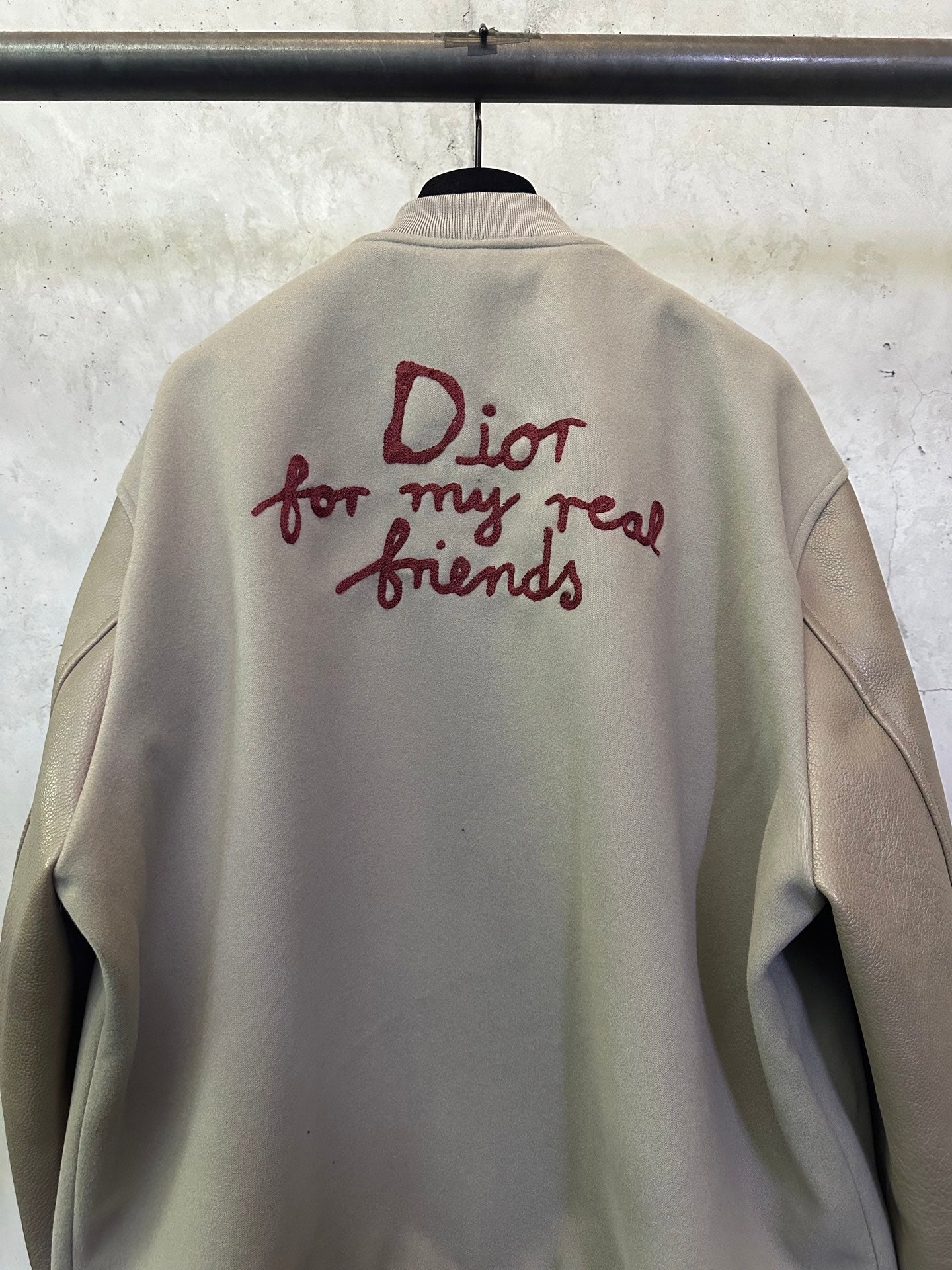 Olive jacket back featuring burgundy “Dior for my real friends” graphic