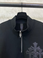 Black hoodie with half-zip, zipper pull, and raised cross emblem detail.