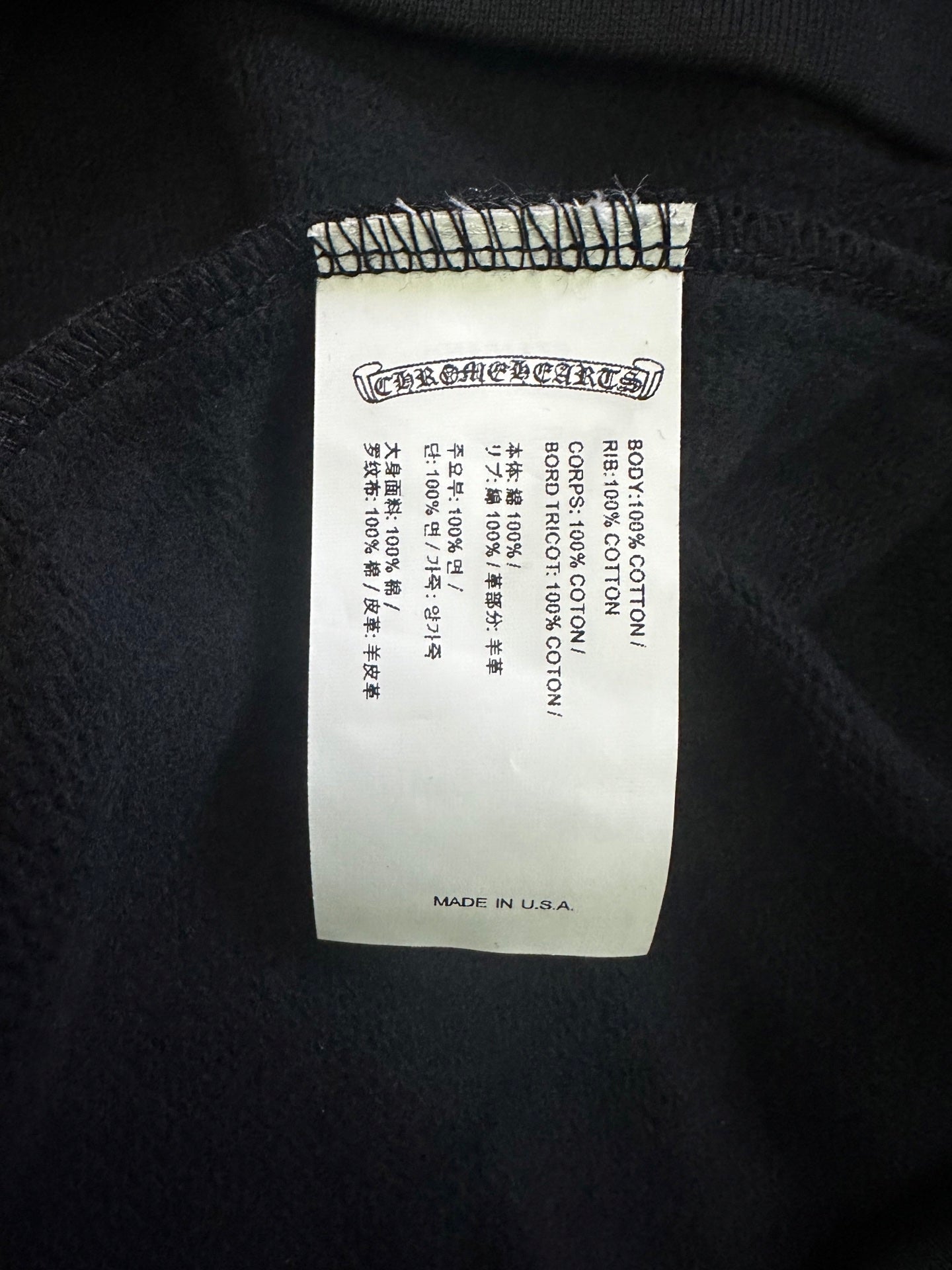 White size label on black hoodie interior, with 'MADE IN USA' at bottom.