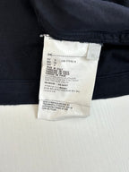 Prada long jacket interior label with size and care information on dark navy fabric
