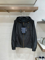Black hooded jacket with full front zip and gold hardware, front view.