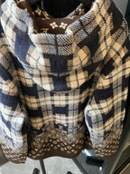 Hooded sweatshirt front close-up with plaid hood lining and brown monogram panel