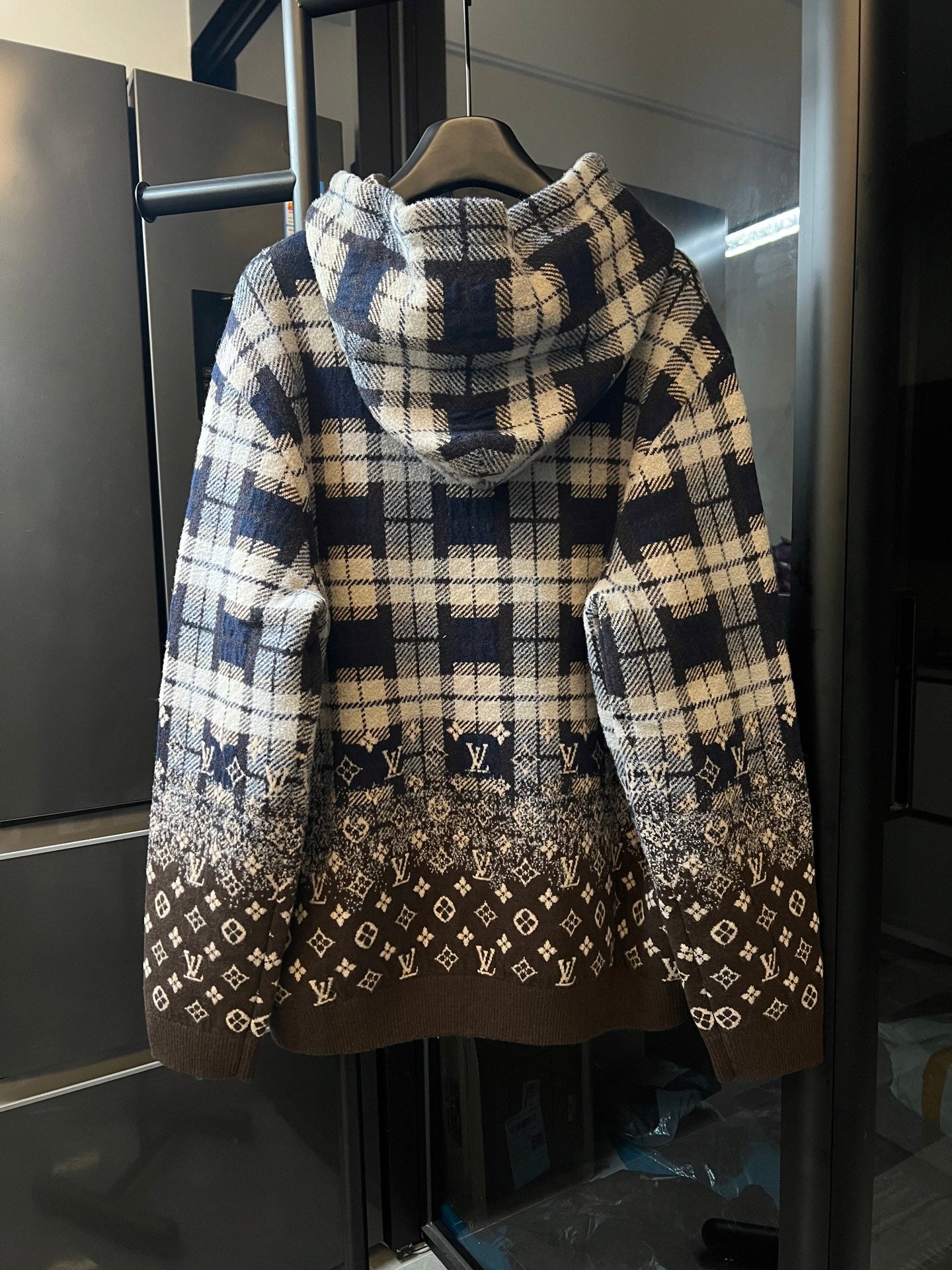 Long-sleeve hooded sweatshirt with plaid back and brown monogram panel near hem