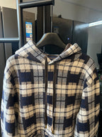Plaid zip-up hoodie with cream and navy blocks, hood, and drawstring details