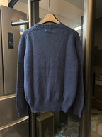 Dark blue knit sweater, back view with ribbed crew neck and hem