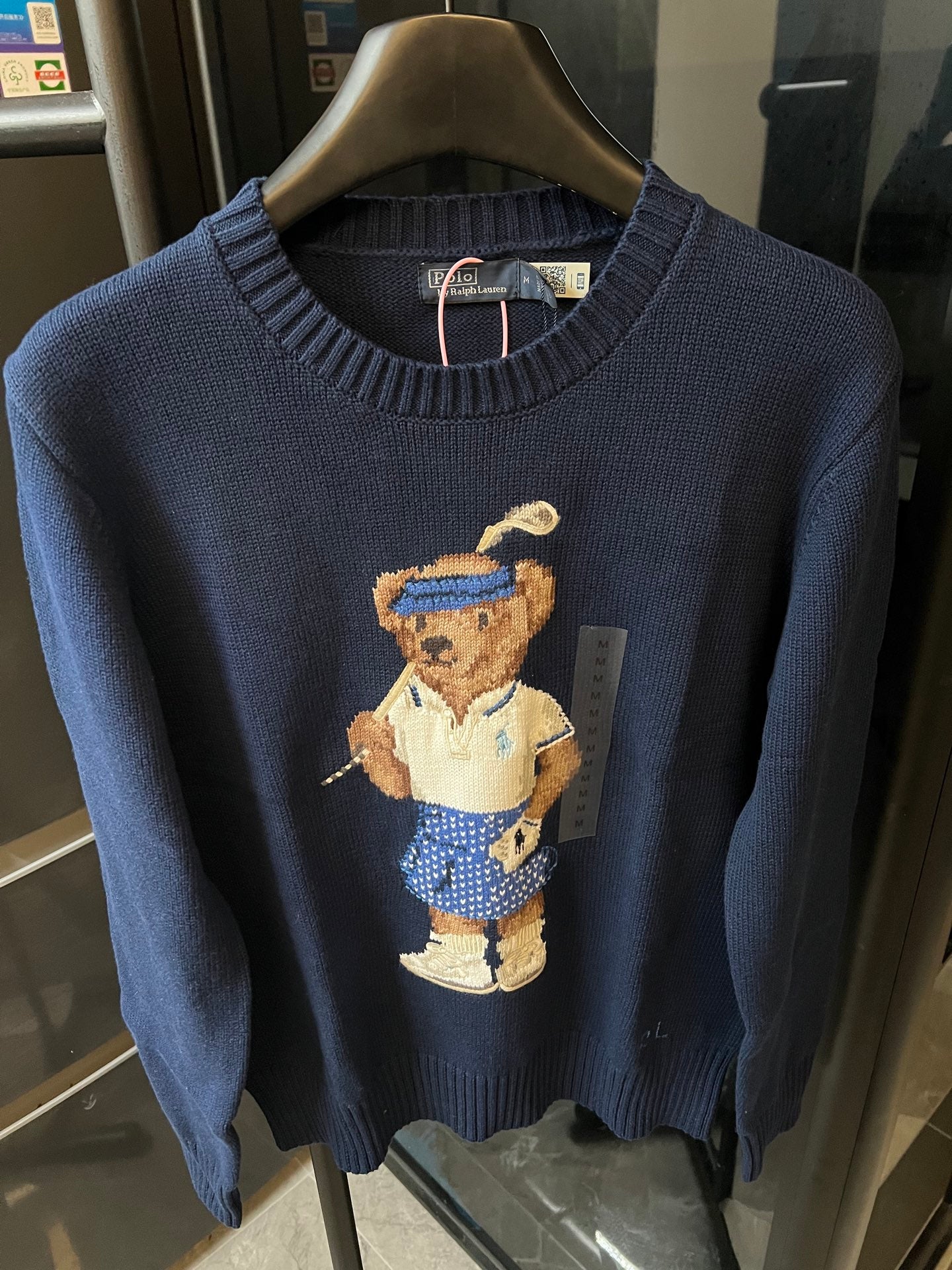 Dark blue knit sweater with bear character graphic and ribbed neckline