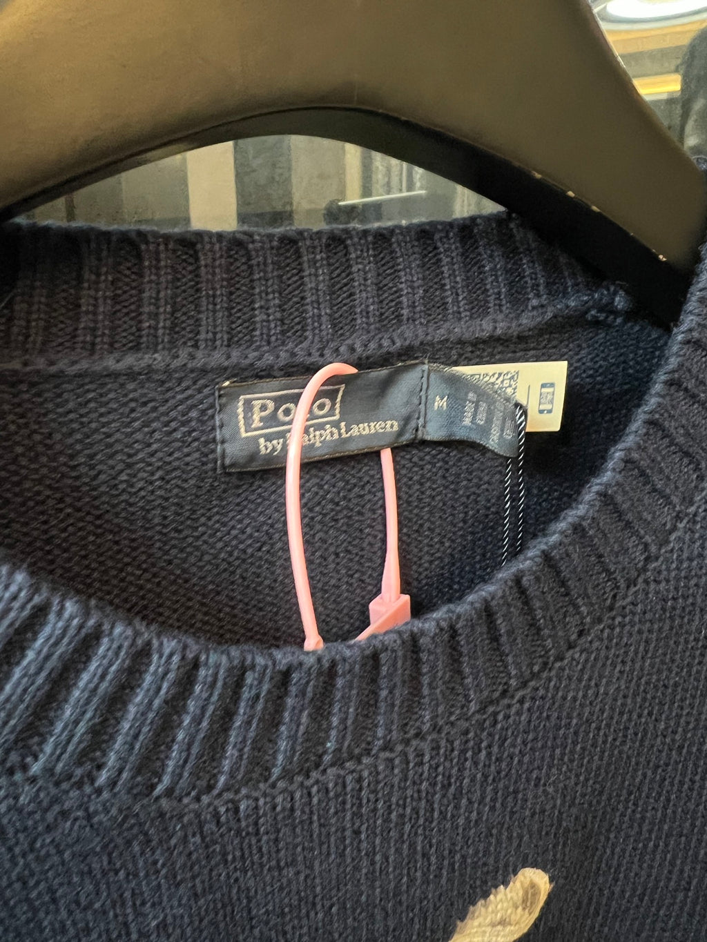 Dark blue knit sweater neckline with Polo by Ralph Lauren label and tags