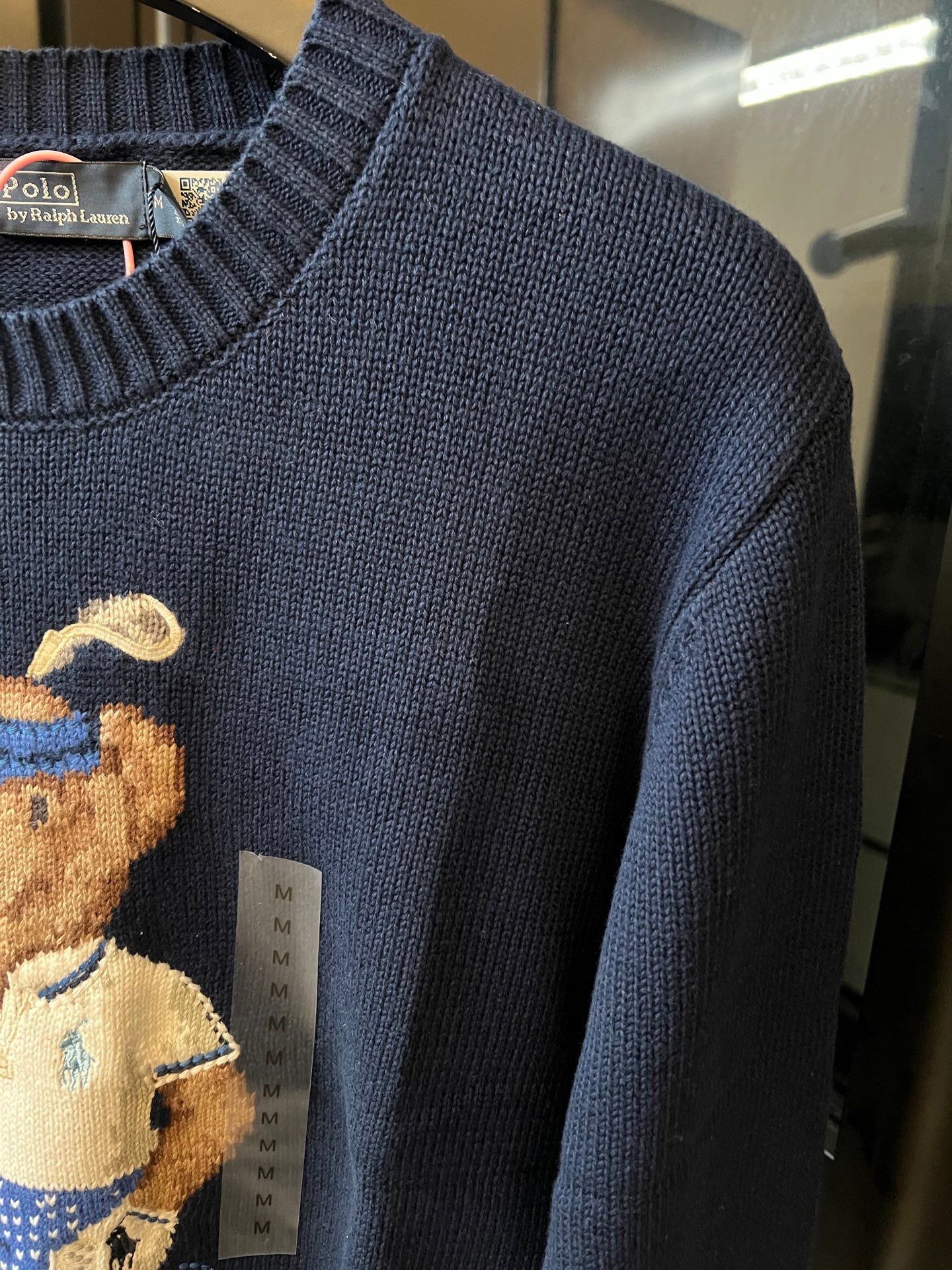 Dark blue knit sweater with ribbed collar and close-up of textured fabric