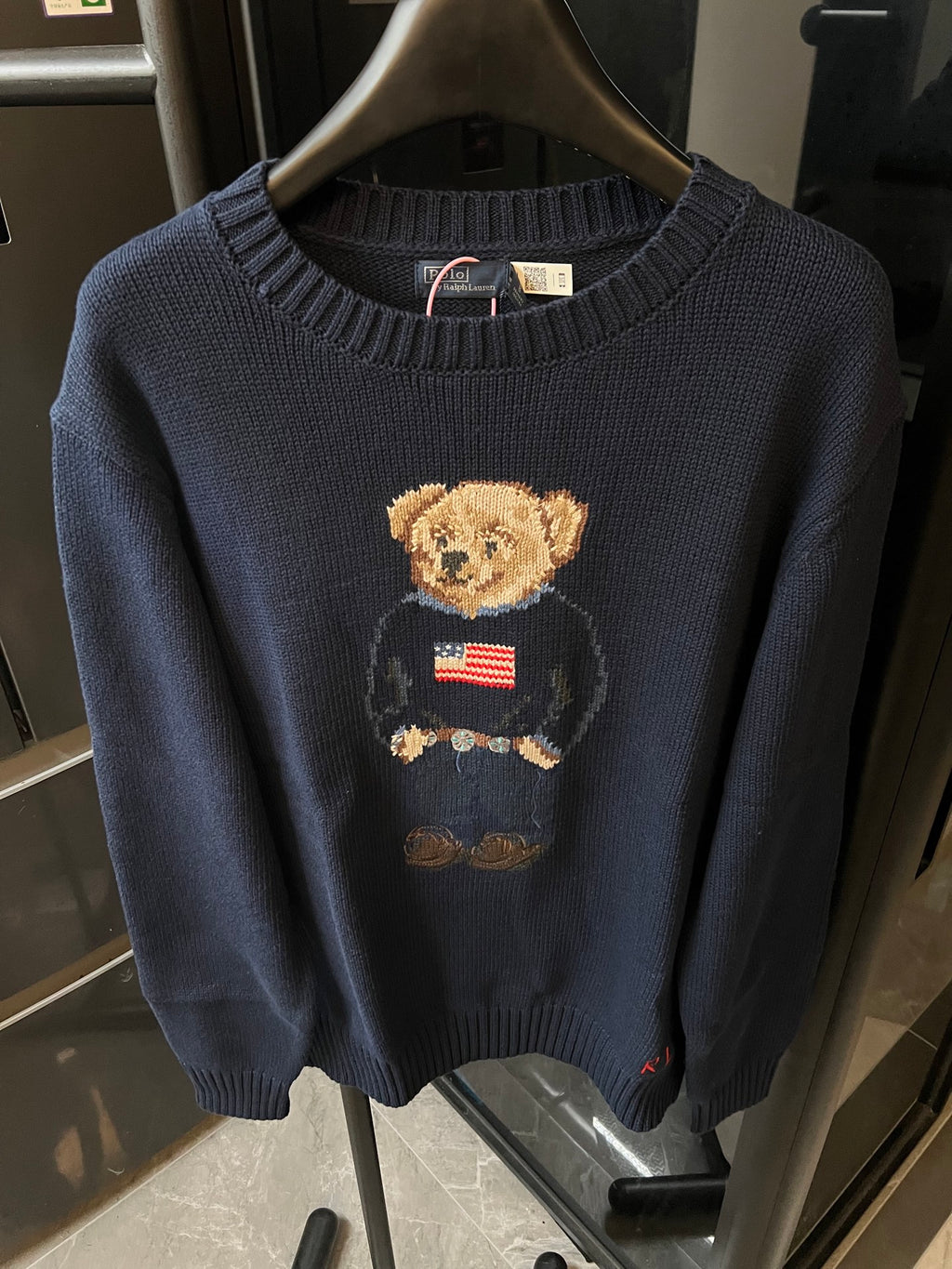 Navy knit sweater with teddy bear holding an American flag graphic