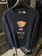 Navy knit sweater with teddy bear holding an American flag graphic