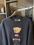 Navy knit sweater with teddy bear face and American flag chest graphic