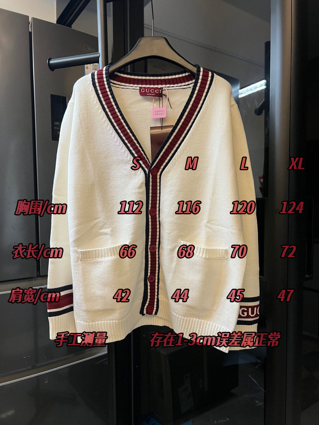 Cream Gucci knit cardigan front view on hanger with V-neck stripes and button placket