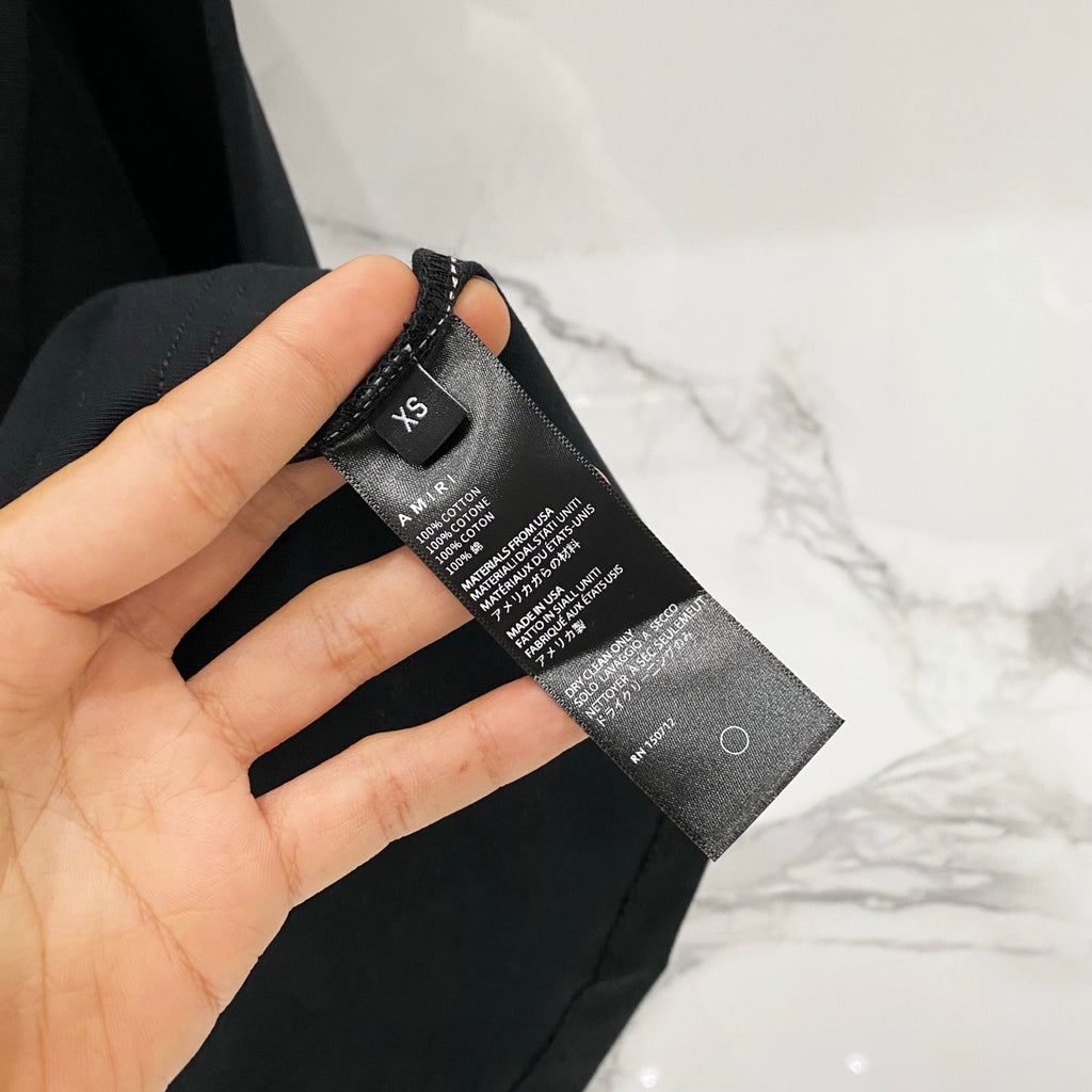 Black T-shirt care label and size information tag