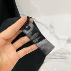 Black T-shirt care label and size information tag