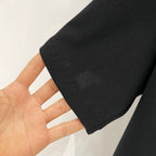 Black T-shirt sleeve hem with visible double stitching