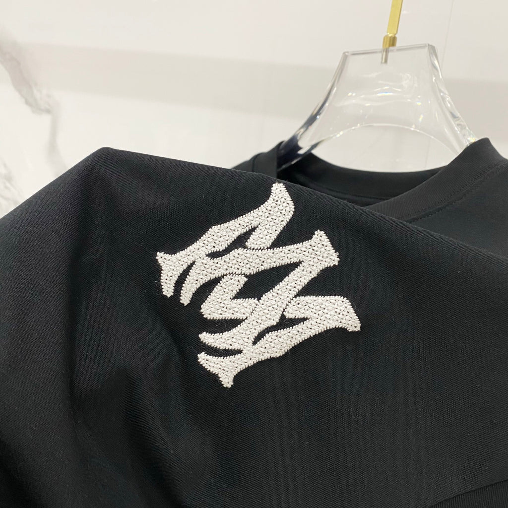 Black T-shirt with large white logo graphic on shoulder