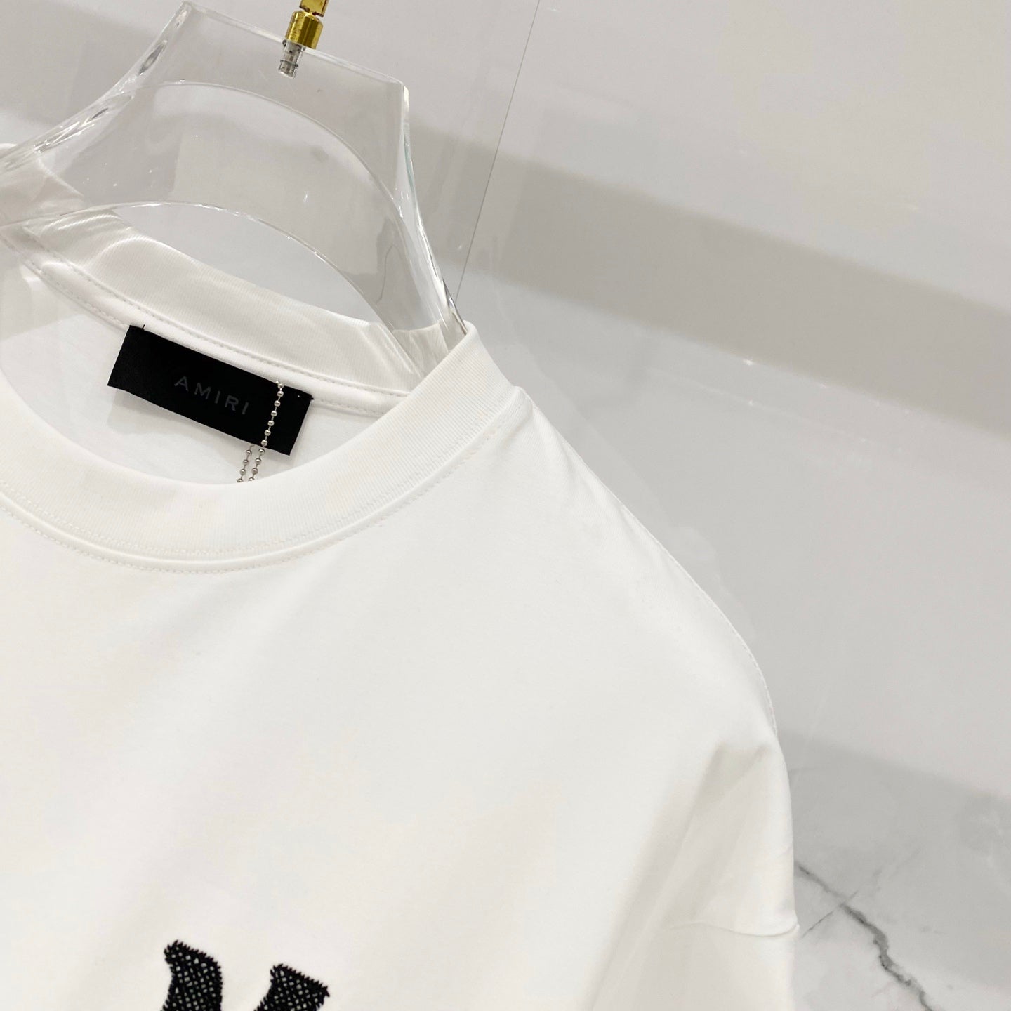 White Amiri T-shirt crew neck close-up with black side lettering