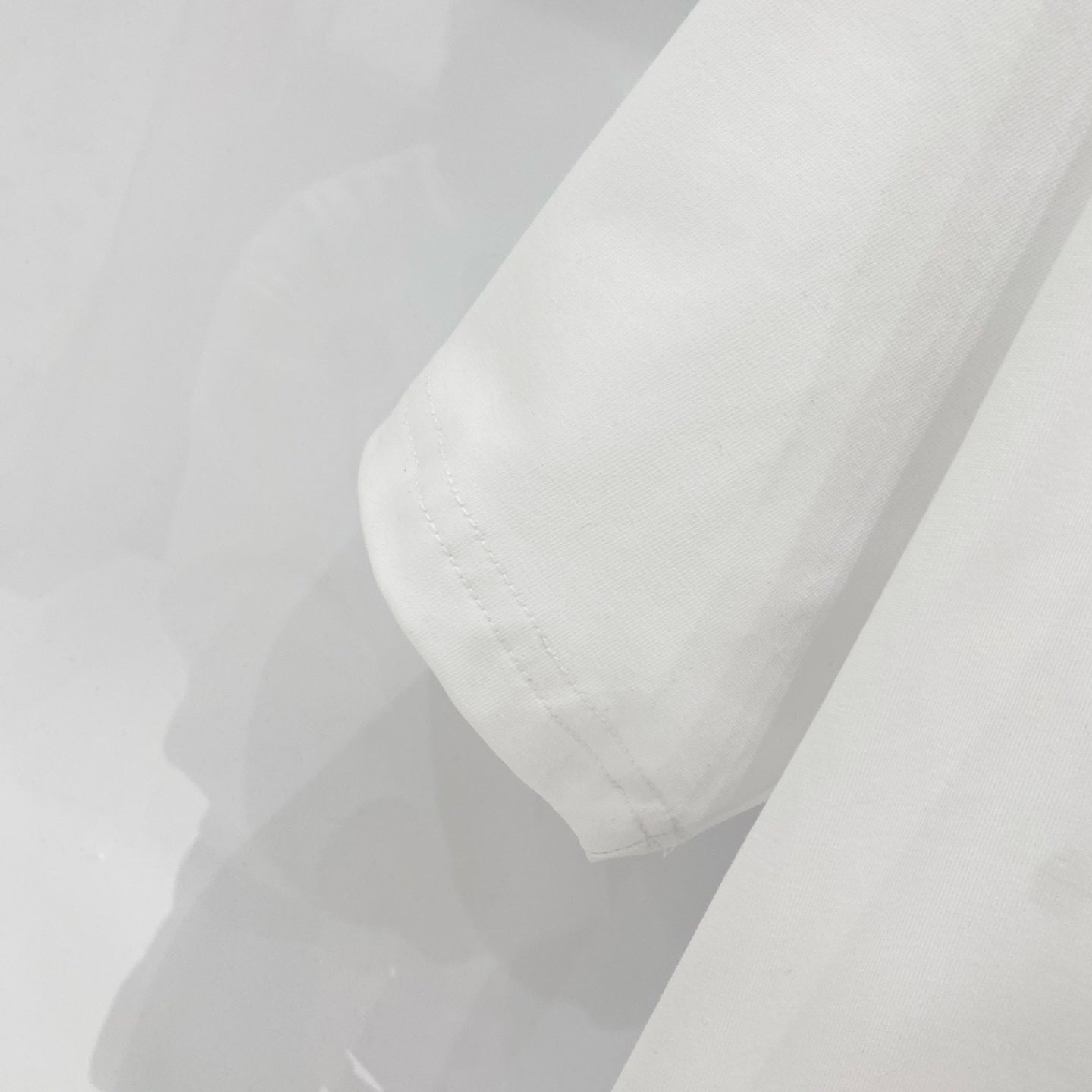 White Amiri T-shirt sleeve and hem with stitched seams