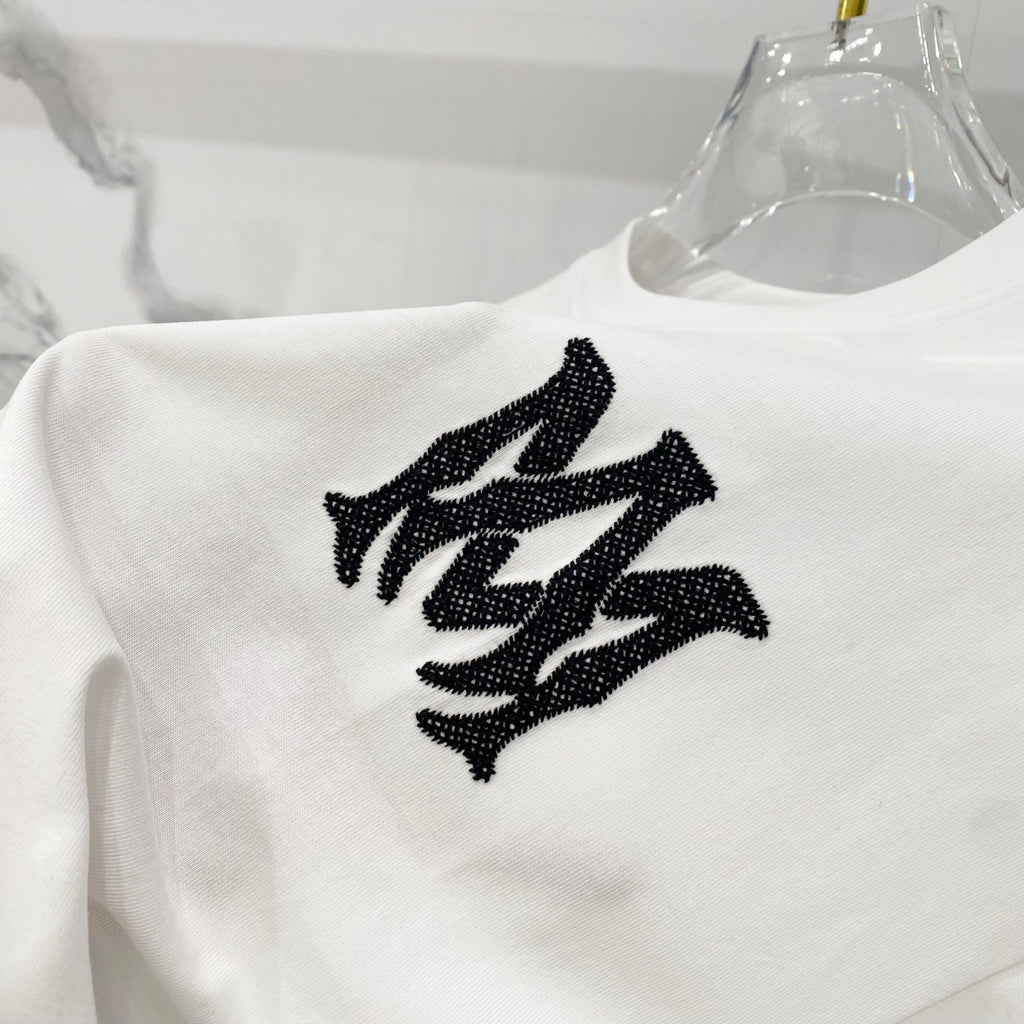 White Amiri T-shirt close-up of large black graphic logo