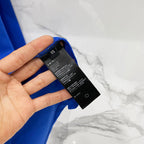 Blue T-shirt with size and care label shown at the inner neck
